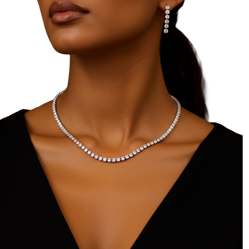 Close-up of a woman wearing a diamond tennis necklace and earrings on a white background