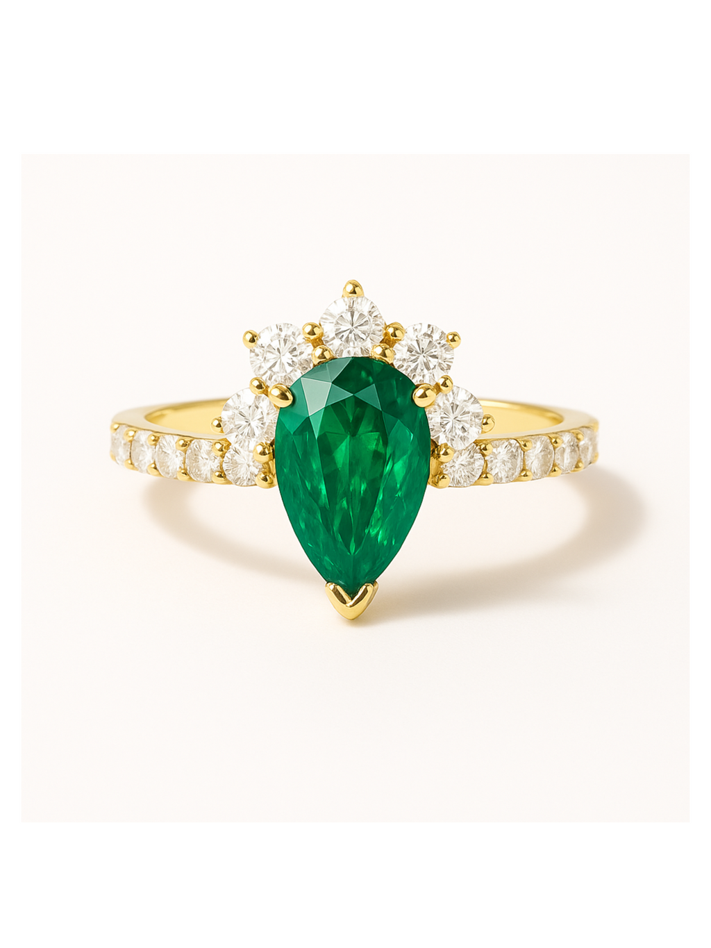Emerald Diamond Gold Ring - Queens Crown features a pear-shaped emerald centerpiece with a crown of round diamonds on a gold band. Elegant gold jewelry ring for luxury wear.