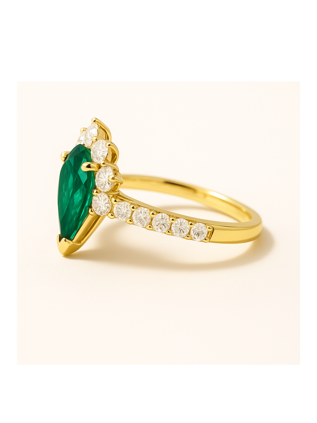 Emerald Diamond Gold Ring - Queens Crown features a pear-cut emerald centerpiece with round diamonds on a polished gold band. Elegant gold jewelry for luxury style.