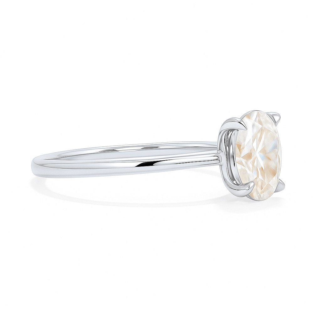 Close-up side view of platinum solitaire ring with an oval lab grown diamond, showcasing its brilliant cut and clean setting.