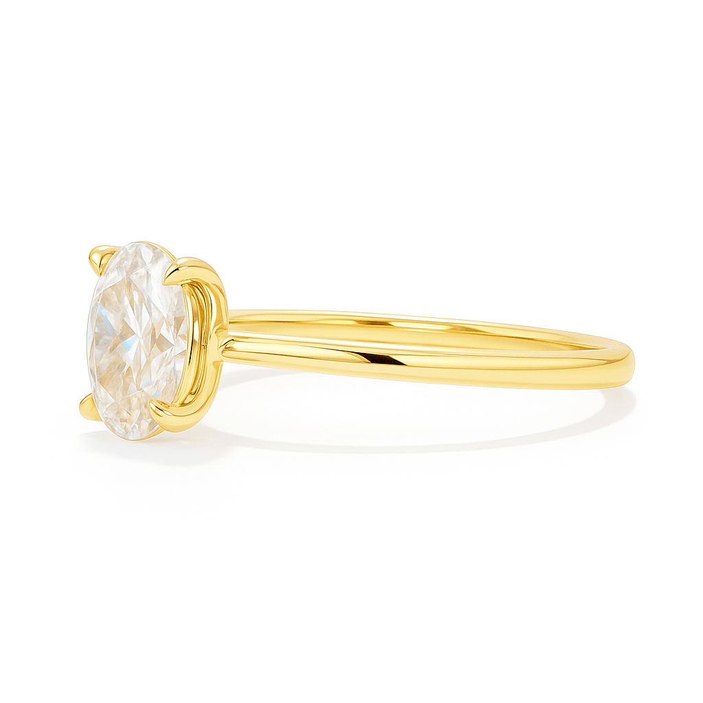 Side view of yellow gold oval cut engagement ring featuring a lab grown VVS1 diamond in a classic four-prong solitaire setting.
