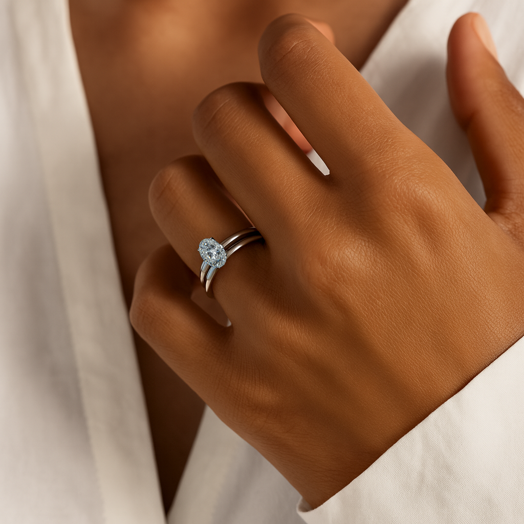 Hand wearing a diamond ring with a soft focus background